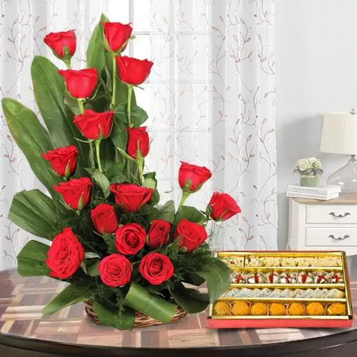 Exotic Gift of 1/2 Kg. Assorted Sweets and 18 Red Roses Bouquet