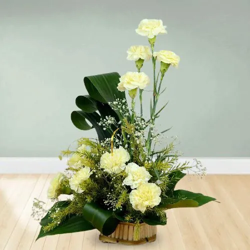 Graceful White Carnations Basket Decorated with Greens