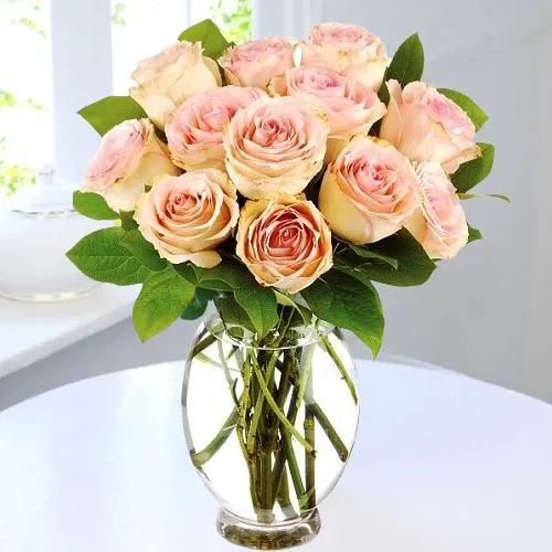 Designer Display of Peach Roses with Green Leaves in Glass Vase