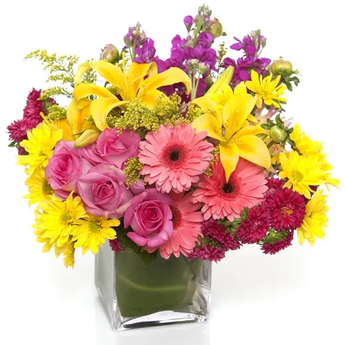 Awesome Display of Mixed Seasonal Flowers in a Glass Vase