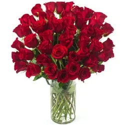 Artful Display of Two Doz Red Roses in a Glass Vase