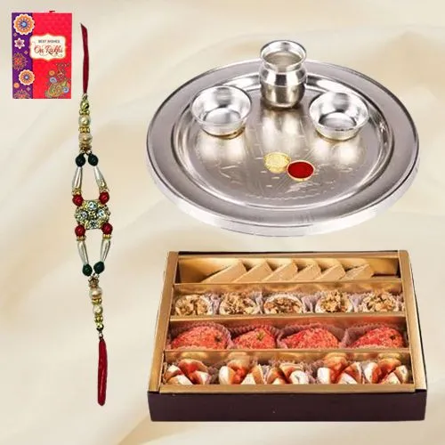 Assorted Sweets and Stylish and Trendy looking Silver Plated Paan Shaped Puja Aarti Thali along Rakhi, Roli, Tilak and Chawal