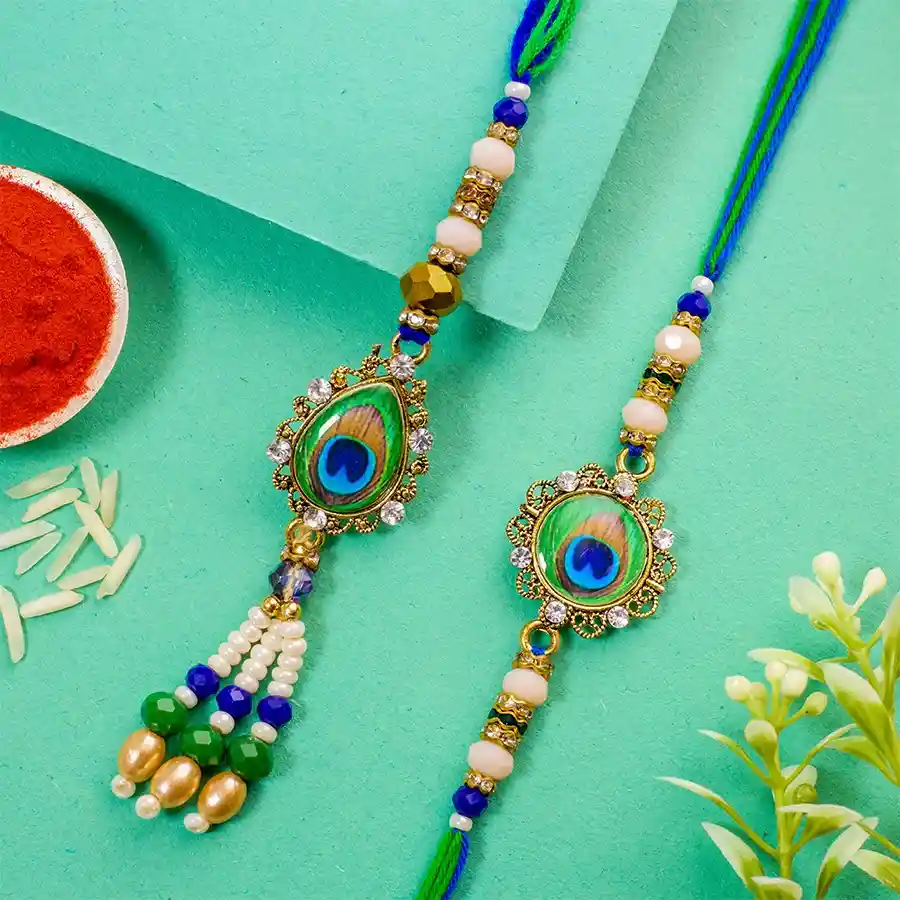 Astonishing Bhaiya Bhabhi Love Rakhi Set featuring shimmering beaded rakhis, decorated with vibrant colors and accompanied by Roli, Tilak, and Chawal in a festive packaging.
