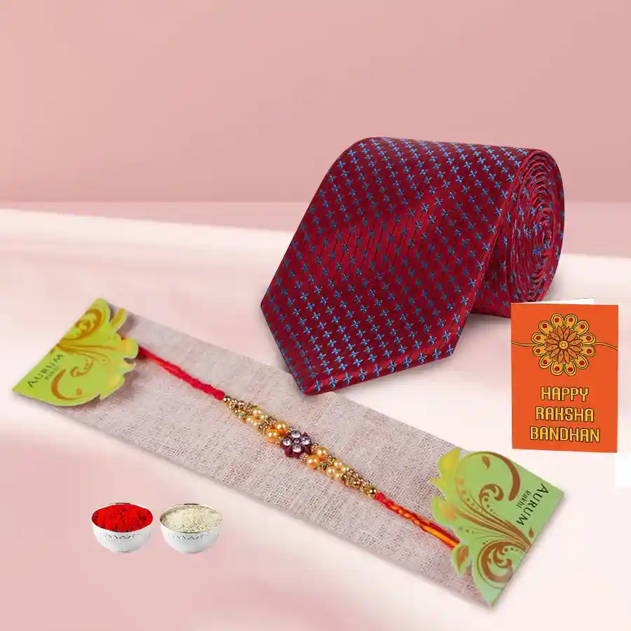 Beautiful Silken Raymond Tie with a colorful Rakhi, Roli Tilak, and Chawal, elegantly presented for Raksha Bandhan celebration.