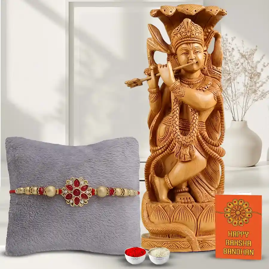 Sandalwood statue of Lord Krishna with a decorative Rakhi, Roli Tilak, and Chawal, elegantly displayed for Raksha Bandhan celebrations.
