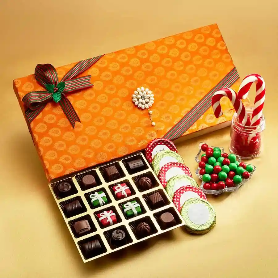 Elegant silk brocade box filled with assorted gourmet chocolates including truffles, marzipan, chocolate-coated biscuits, and candy canes.
