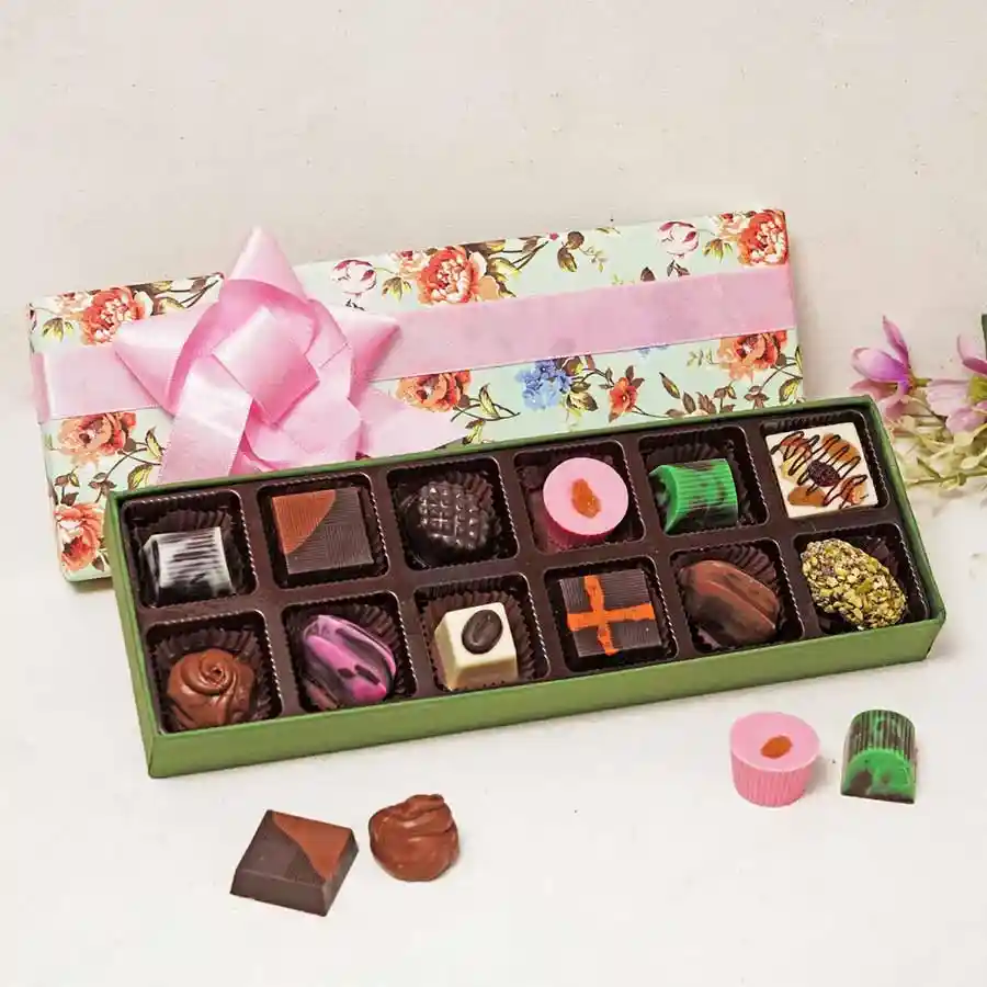 Luxurious assorted chocolate treats in an elegant box featuring various flavors like Pistachio, Almond Rock, Strawberry Soft Filled, Dark, Milk, Mint, and Pistachio Date