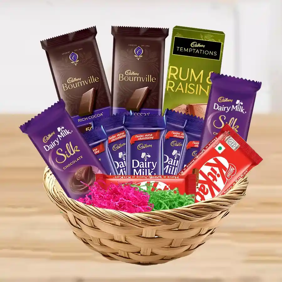 Delectable basket filled with assorted chocolates including Cadbury Dairy Milk, Dairy Milk Silk, Rum n Raisin, Almond bars, Nestle KitKats, and Cadbury Bournville, elegantly arranged as a gift.