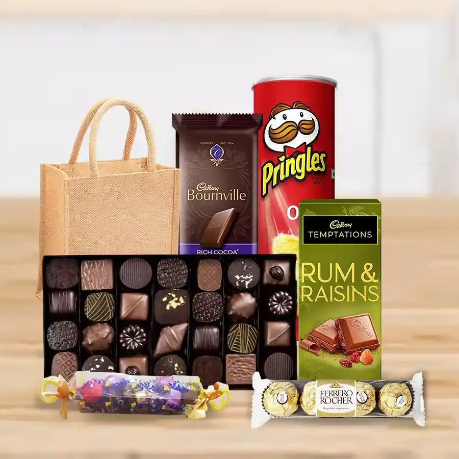 Delectable Mother's Day chocolate hamper featuring Pringle Chips, homemade chocolates, Cadbury Bourneville and Temptation Rum & Raisin bars, Ferrero Rocher, all arranged in a charming jute or tote gift bag.
