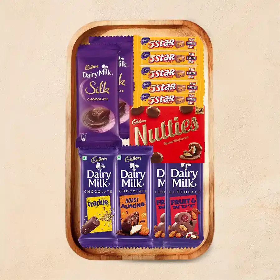 Tray of assorted Cadbury chocolates including Dairy Milk Silk, Roast Almond, Crackle, Fruit & Nut, Nutties, and Five Star, elegantly presented on a wooden tray.