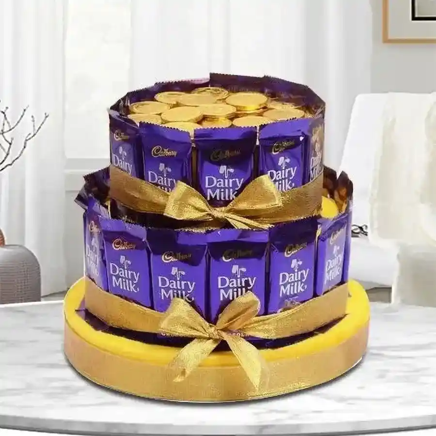 Delectable tower arrangement of Cadbury Dairy Milk chocolates and gold coin chocolates on a golden base, finished with a luxurious golden ribbon.