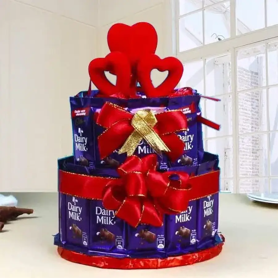 Two-tier arrangement of 25 Cadbury Dairy Milk chocolates and heart-shaped homemade treats, elegantly tied with vibrant ribbons.