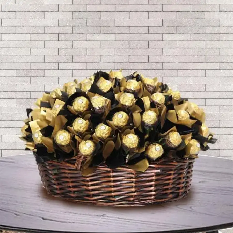 A beautifully arranged basket filled with 32 Ferrero Rocher chocolates, each wrapped in gold foil, set against a soft background.