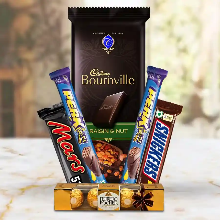 Assorted chocolates hamper featuring Ferrero Rocher, Mars Choco pack, Cadbury Bournville bar, Perk wafers, and Snickers bar arranged beautifully.