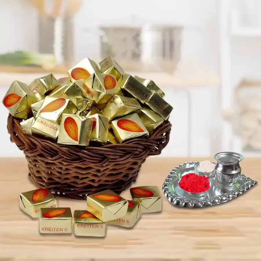 Almond toffee in a decorative basket next to a silver plated puja thali