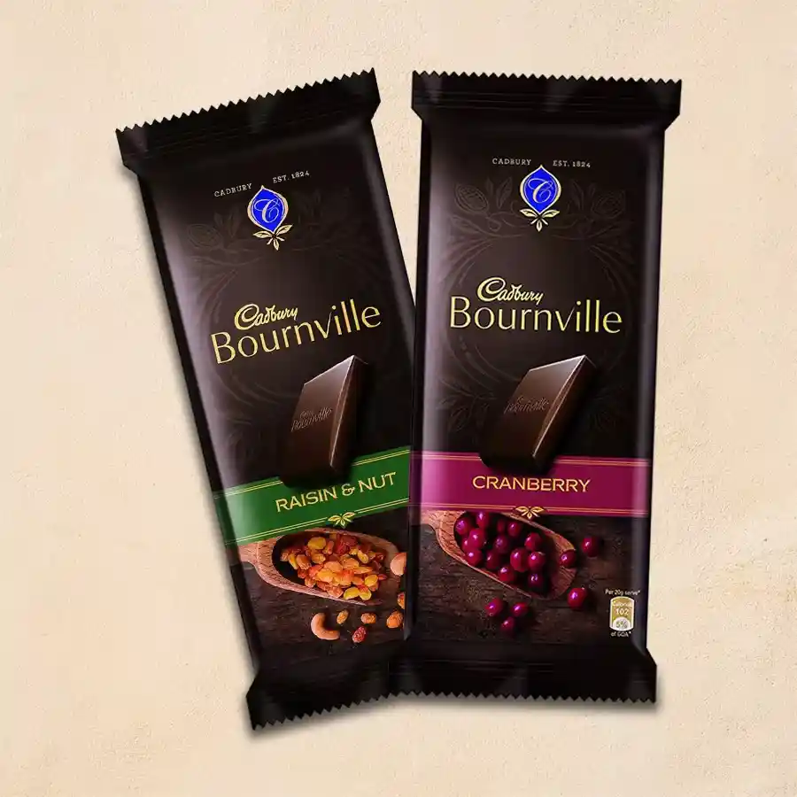 Two packs of Cadbury Bournville Chocolates, one with Raisins & Nuts and the other with Cranberries, displayed together.