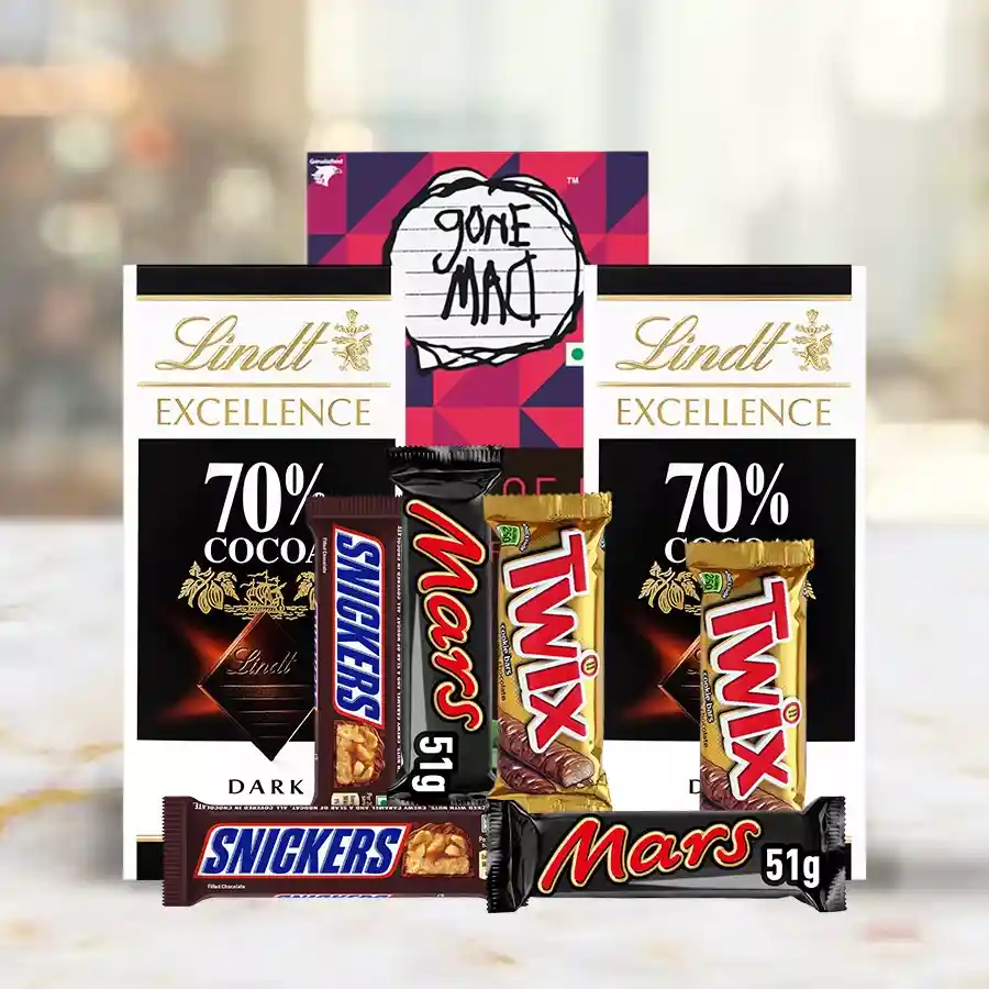 Imported Chocolates Basket featuring Lindt Excellence Bars, Snickers, Twix, Mars bars, and Gone Mad Chocolate Bars, beautifully arranged for gifting.