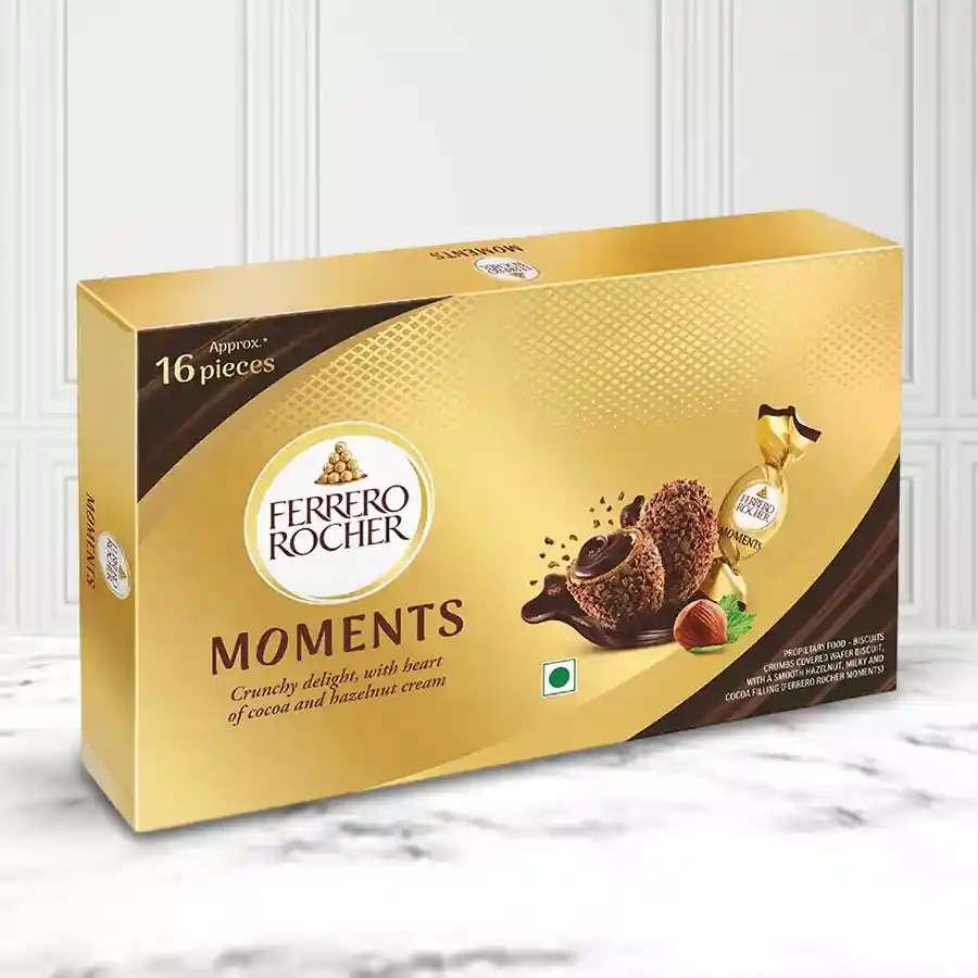 Ferrero Rocher Moment box containing 16 gold-wrapped chocolates on a decorative background.