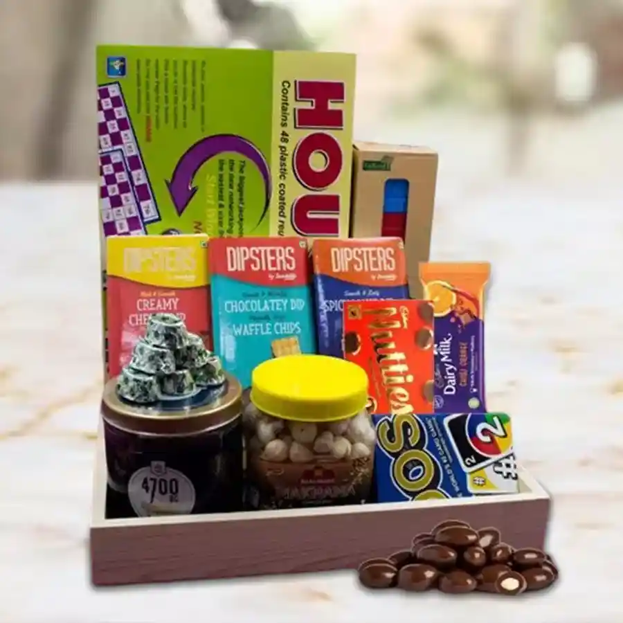 Lovely Evening Kitty Party Hamper featuring Himalayan Salt Caramel Popcorn, Cadbury chocolates, Dipsters dips with chips, classic games like Uno and Jenga, handmade dark chocolates, and a wooden tray.