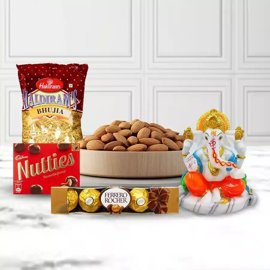 Almonds and chocolates combo with a marble Ganpati idol displayed in a wooden tray