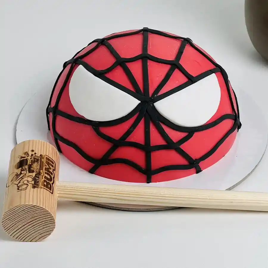Spidey Smash Cake Adventure with colorful Spiderman design and hammer for smashing fun.