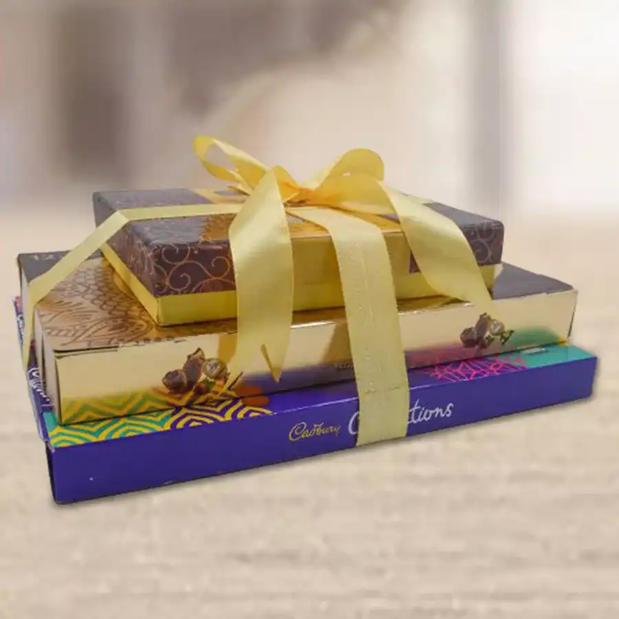 Three-layer chocolate gift tower featuring Premium Truffle Chocolate Box, Ferrero Rocher Moments Box, and Cadbury Celebration Assorted Chocolate Box.