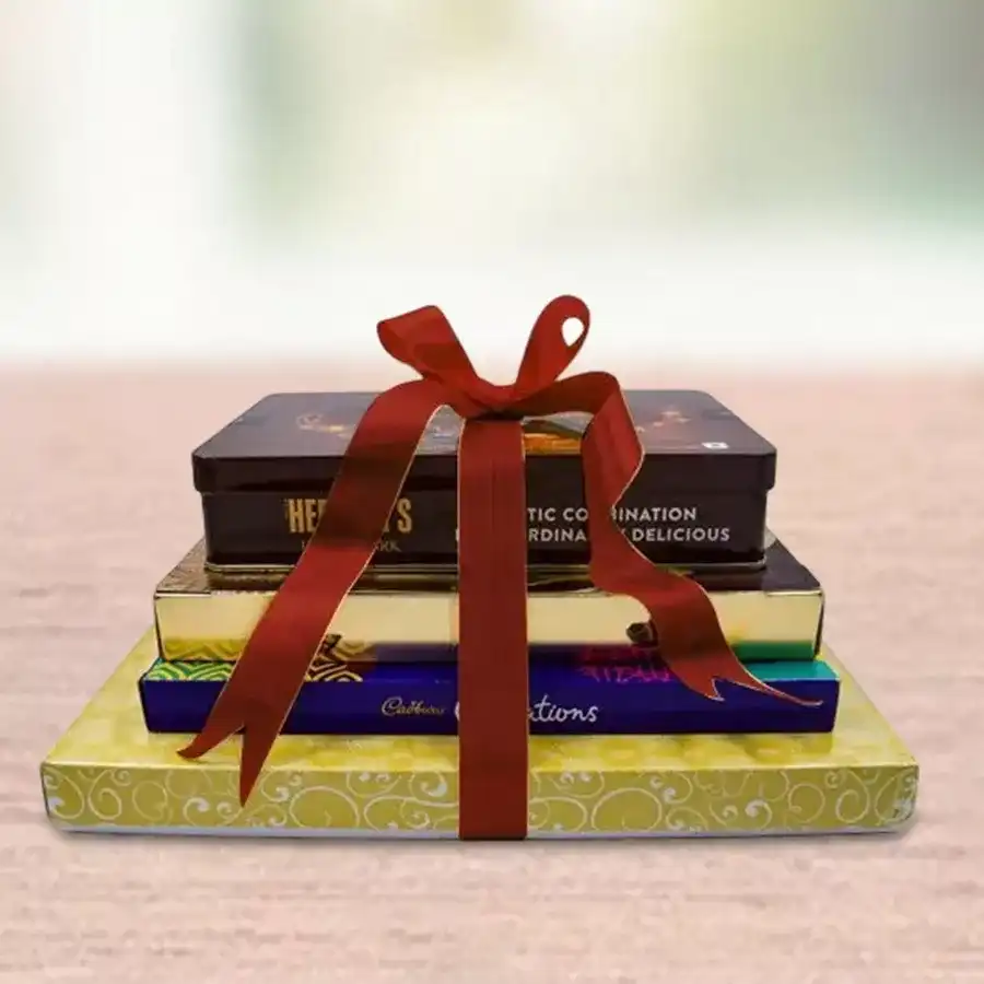 Premium Assorted Chocolate Tower featuring Ferrero Rocher Moments, Hershey’s Kisses Exotic Dark Chocolate, Cadbury Celebration Assorted Chocolates, and Decadent Premium Truffle Chocolates