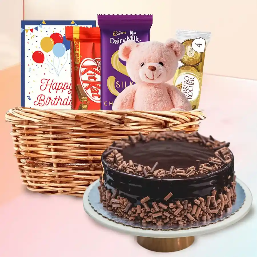 Birthday Joy Basket featuring chocolate cake, teddy bear, and assorted sweets for a joyful celebration.