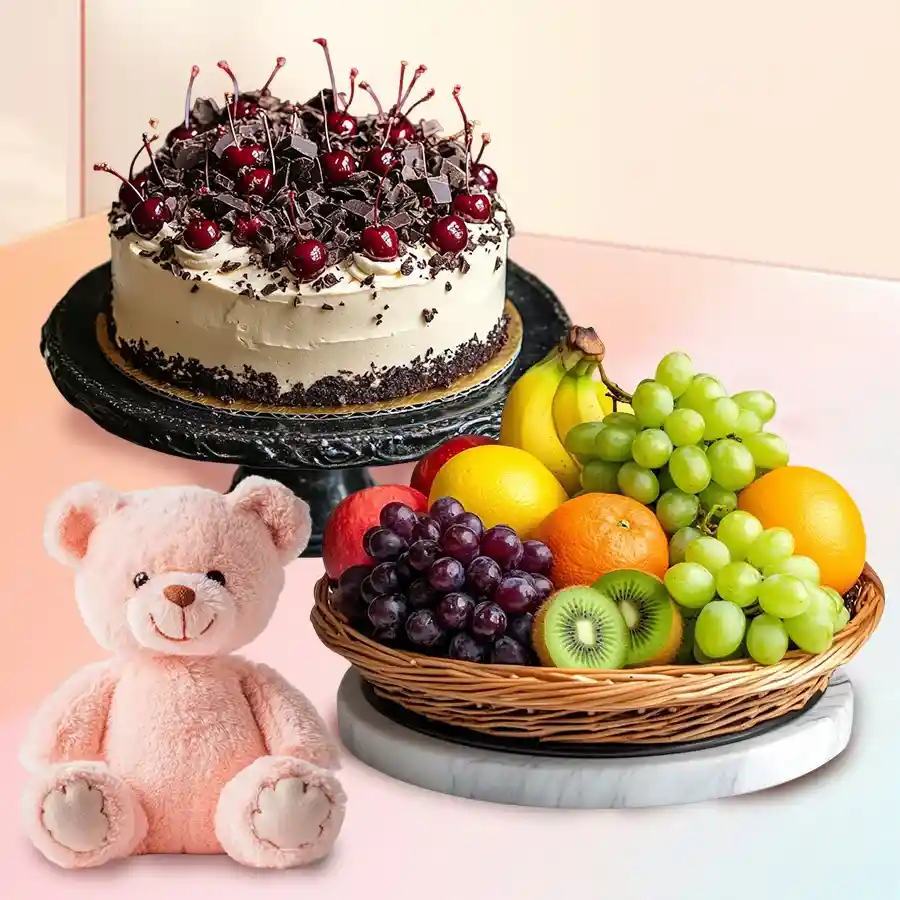 Black Forest cake with teddy bear, candles, and fresh fruit basket.