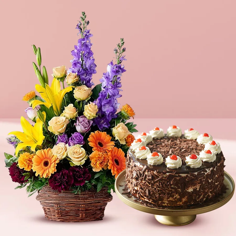 Seasonal flower arrangement with a Black Forest cake for celebrations.