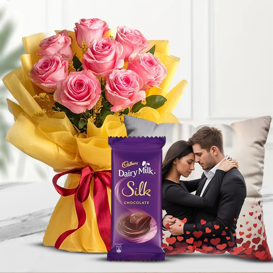 Dreamy bouquet of pink roses, Dairy Milk Silk bar, and customized photo cushion for Valentine's Day gift.