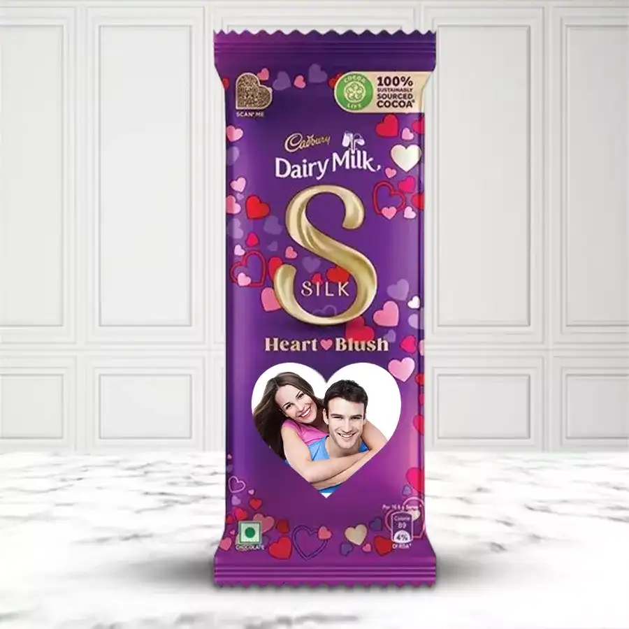 Personalized Cadbury Silk bar with a heart design, featuring a custom photo and message, surrounded by decorative elements.