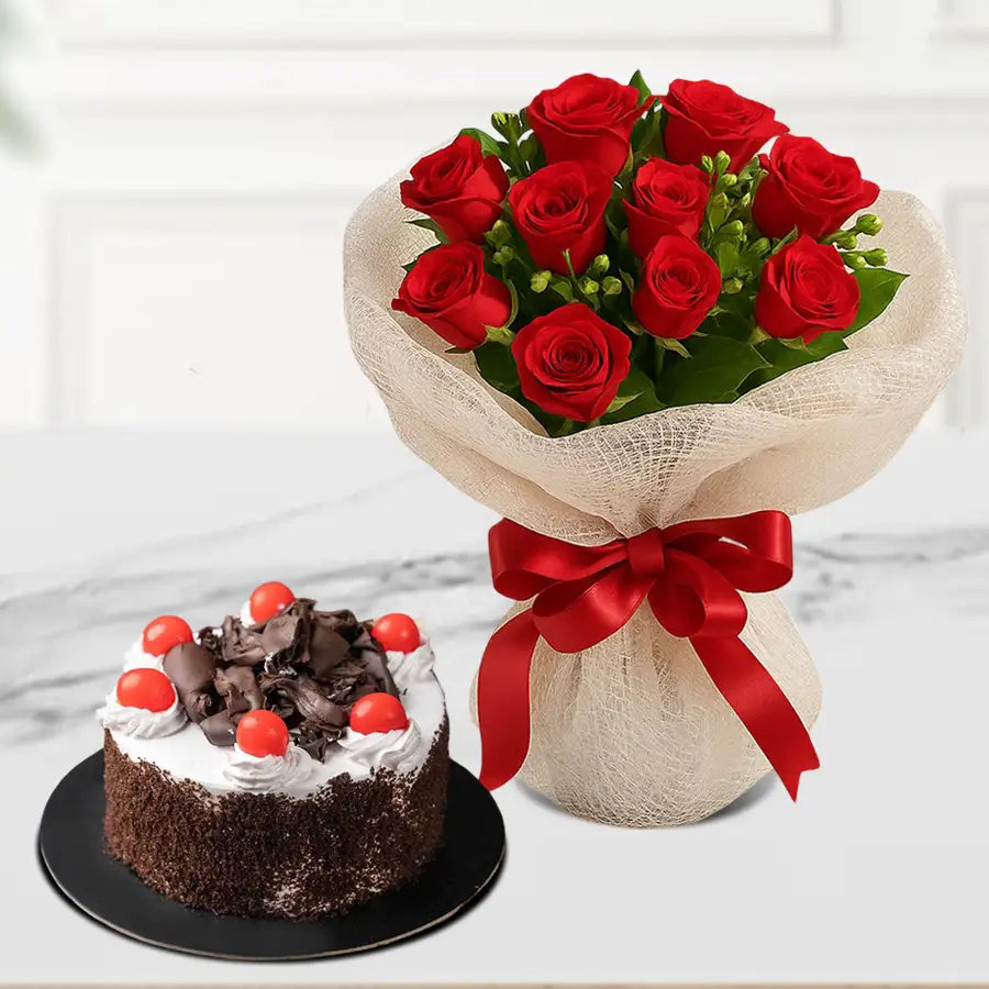 Elegant Black Forest cake with a bouquet of fresh red roses for Kiss Day.