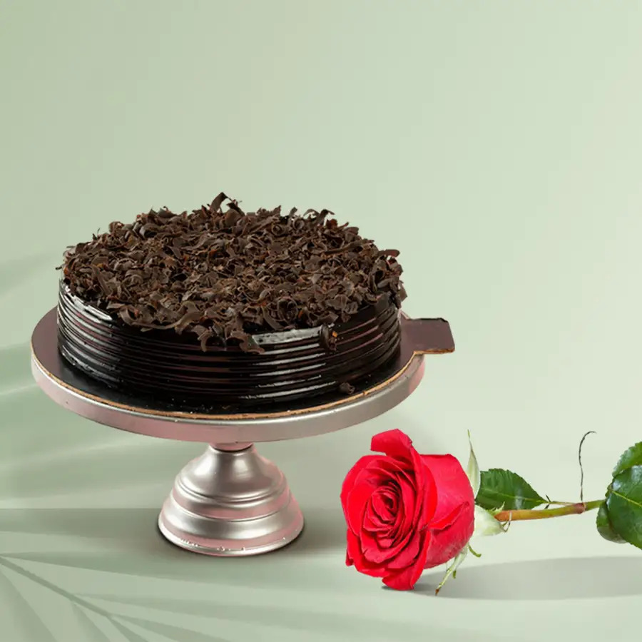 Romantic combo of a chocolate cake and a single red rose for Valentine's Day.