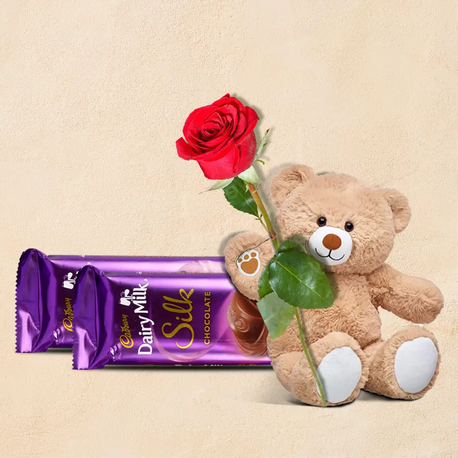 Valentine's gift set featuring Cadbury chocolate, a love teddy, and a red rose.