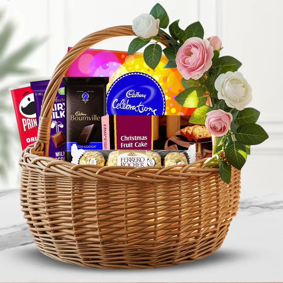 Festive Chocolate & Snack Delight basket with chocolates, Pringles, and a Christmas Plum Cake.