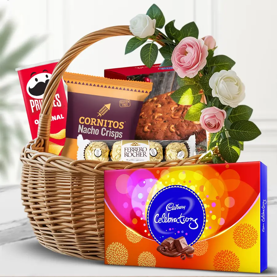 Holiday Crunch & Sweet Bliss Basket featuring Pringles, chocolates, and a plum cake, decorated with mixed flowers for a festive touch.