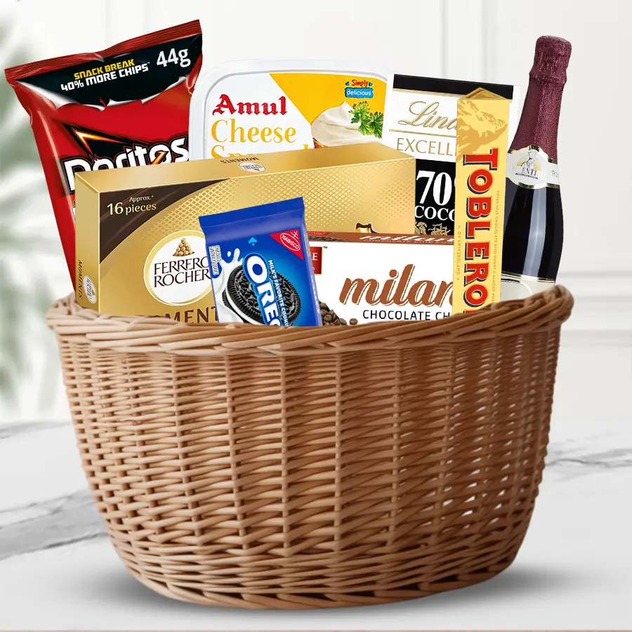 Holiday Bliss Treats & Cheers Basket filled with chocolates, cookies, chips, and sparkling wine perfect for Christmas celebrations.