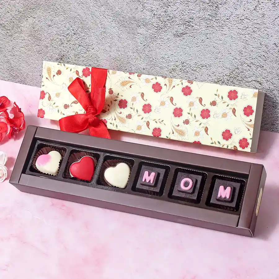 Beautiful Mother's Day Surprise Chocolate Box featuring assorted chocolates stamped with "MOM" in a floral printed box.