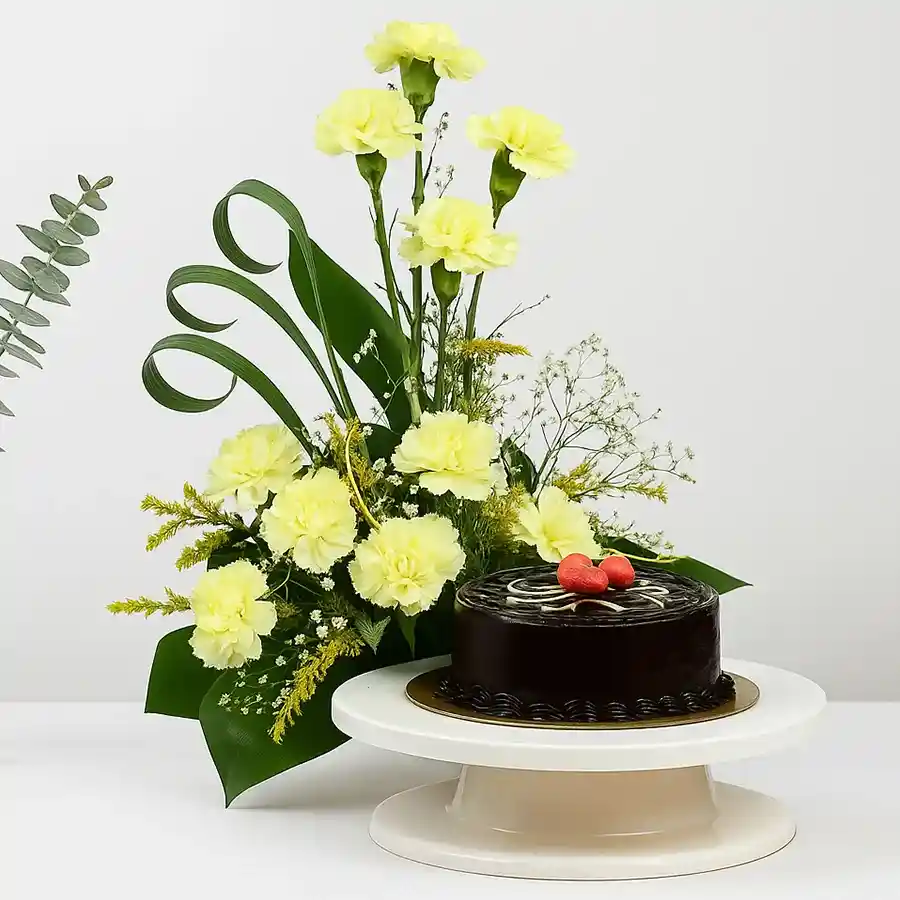 Elegant bouquet of white carnations with gypsophila paired with a round chocolate truffle cake.