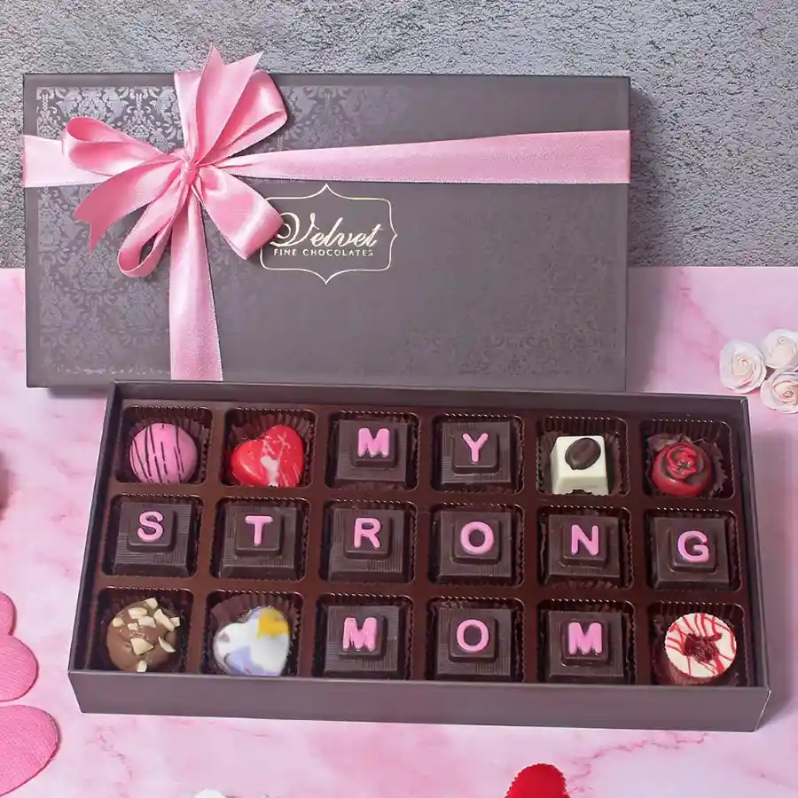 Elegant box of assorted chocolates with "My Strong Mom" stamps, showcasing an array of dark, milk, and white chocolates, perfect for Mother's Day gifting.