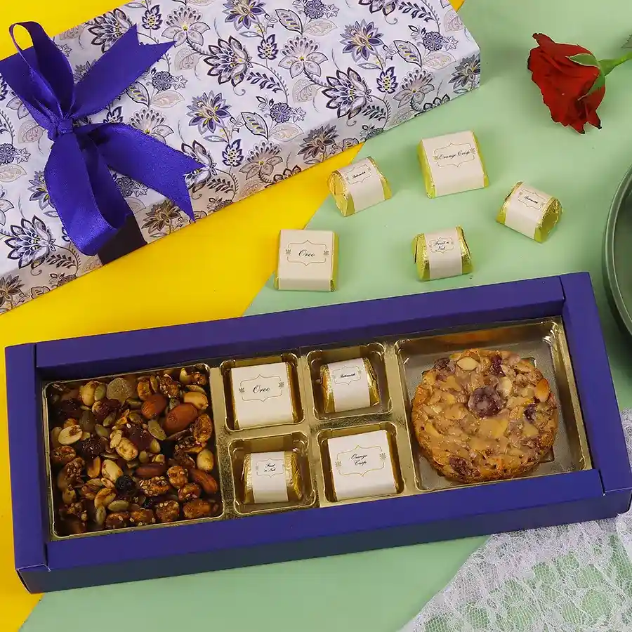 Charming festive box filled with assorted chocolates, a Florentine cookie, and trail mix, showcasing a variety of flavors and textures.