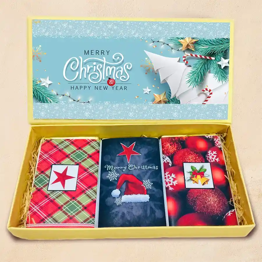Luscious Christmas Choco Treat Hamper featuring festive packaging and three chocolate bars with roasted dry fruits, cranberries, and butterscotch