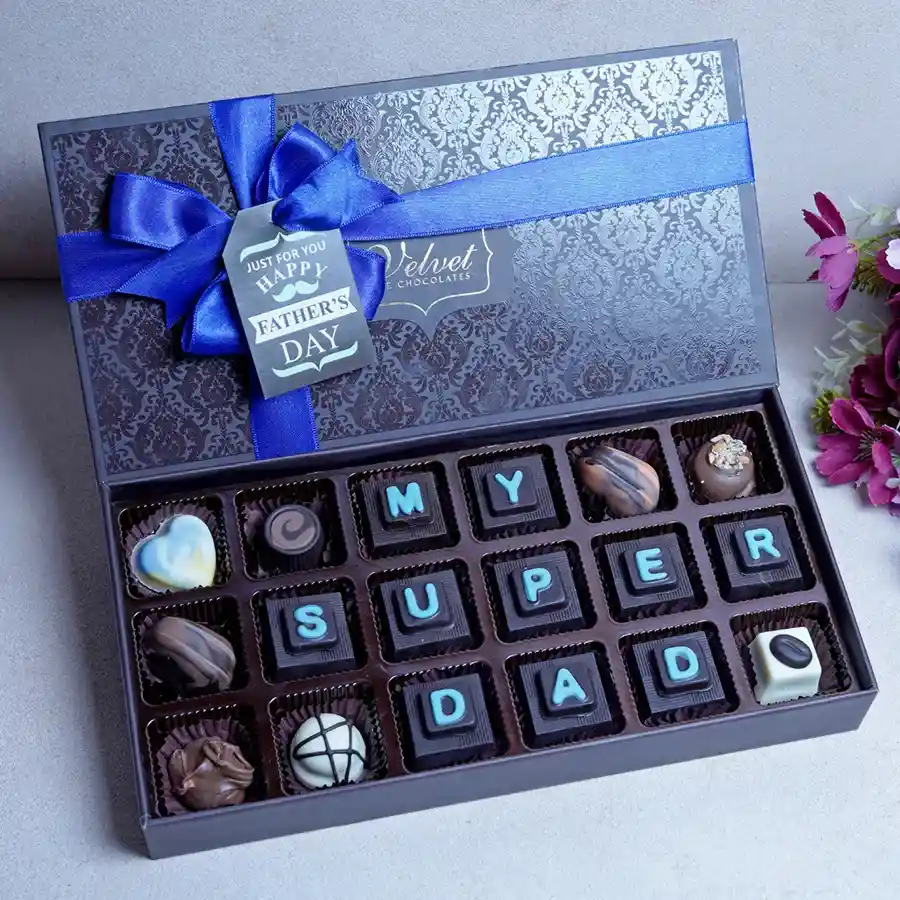 Exquisite Father's Day Choco Delight Box featuring an assortment of chocolates and treats including orange crisps, Oreos, cranberry chocolates, a heart-shaped white treat, hazelnuts, orange and butterscotch delights, almond rocks, Oreo truffles, and coffee bites.