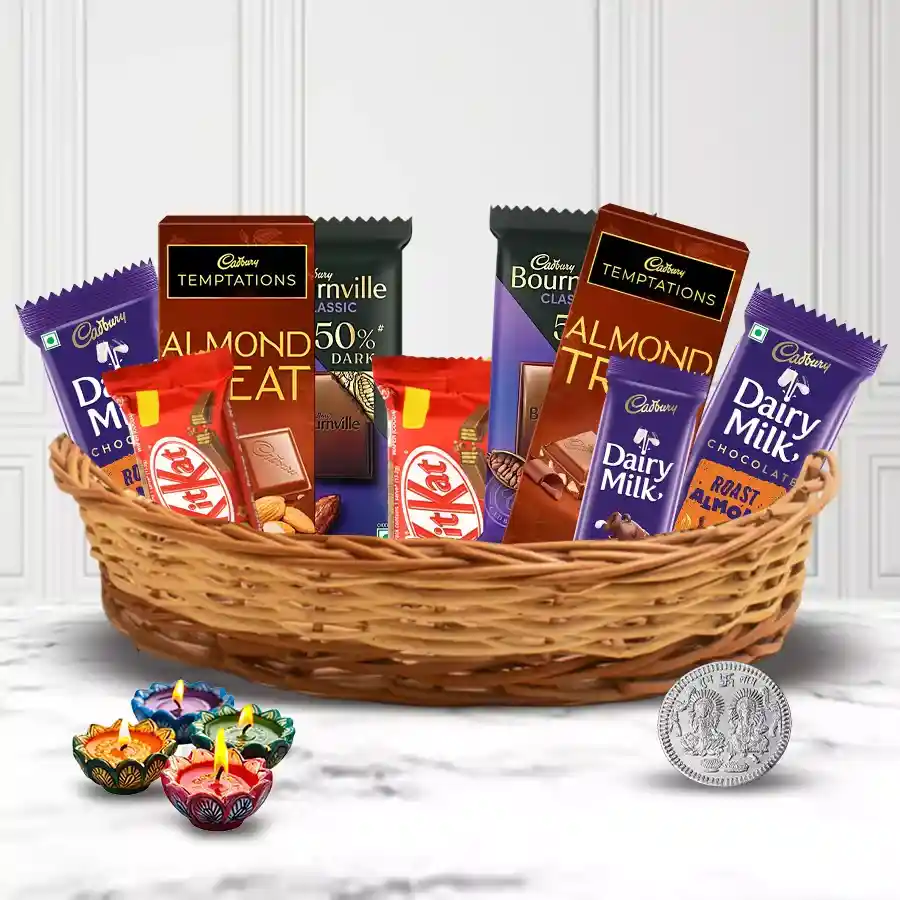 Mouth-watering collection of delightful chocolate gifts for Diwali, featuring assorted chocolates and festive decorations like a silver coin and diyas.