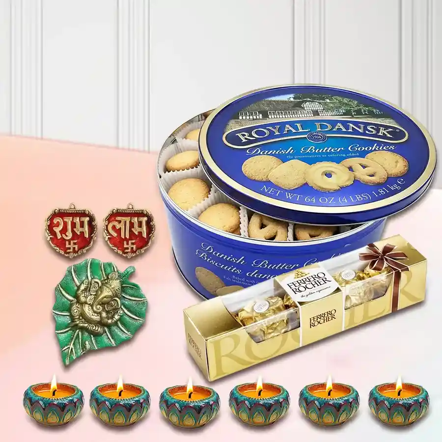 Festive gift combo featuring Ferrero Rocher chocolates, Royal Dansk cookies, wax diyas, and a Subh Labh Banderwal set arranged for Diwali celebration.