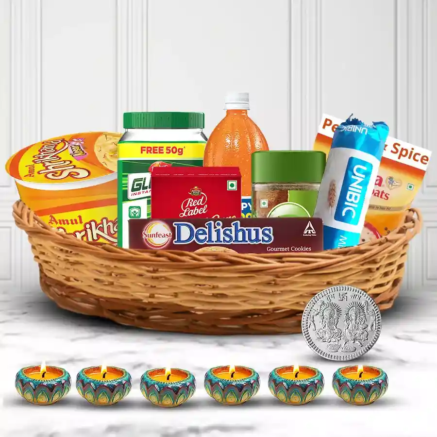 Deepawali gift hamper with treats, diyas, and a silver-plated Lakshmi Ganesh coin
