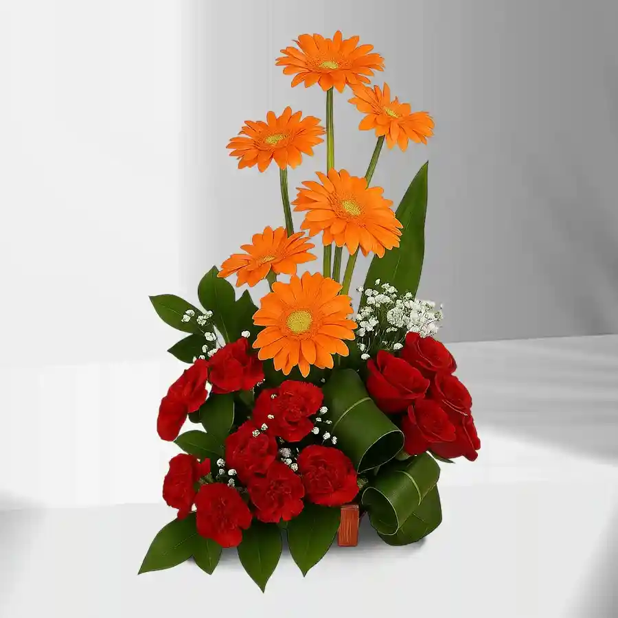 Hand-arranged bouquet of red roses, orange gerberas, and red carnations, designed to celebrate love and joyful moments.