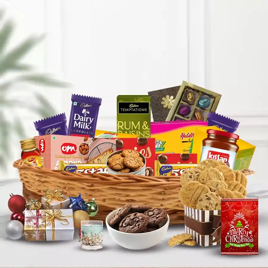All the Best Christmas Collection basket filled with festive treats including cookies, fruit bakes, biscuits, chocolates, honey, marmalade, Christmas decorations, a jelly candle, and a Christmas card.