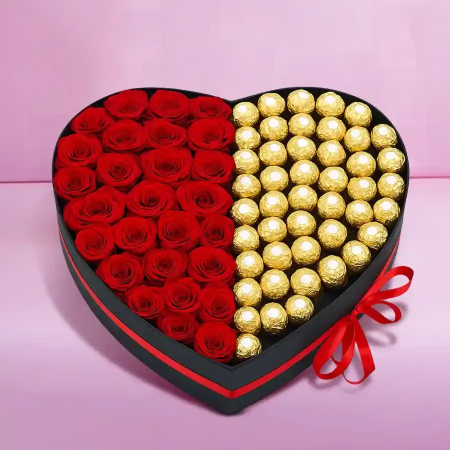 Heart-shaped box containing 24 red roses and 24 Ferrero Rocher chocolates for a romantic gift.